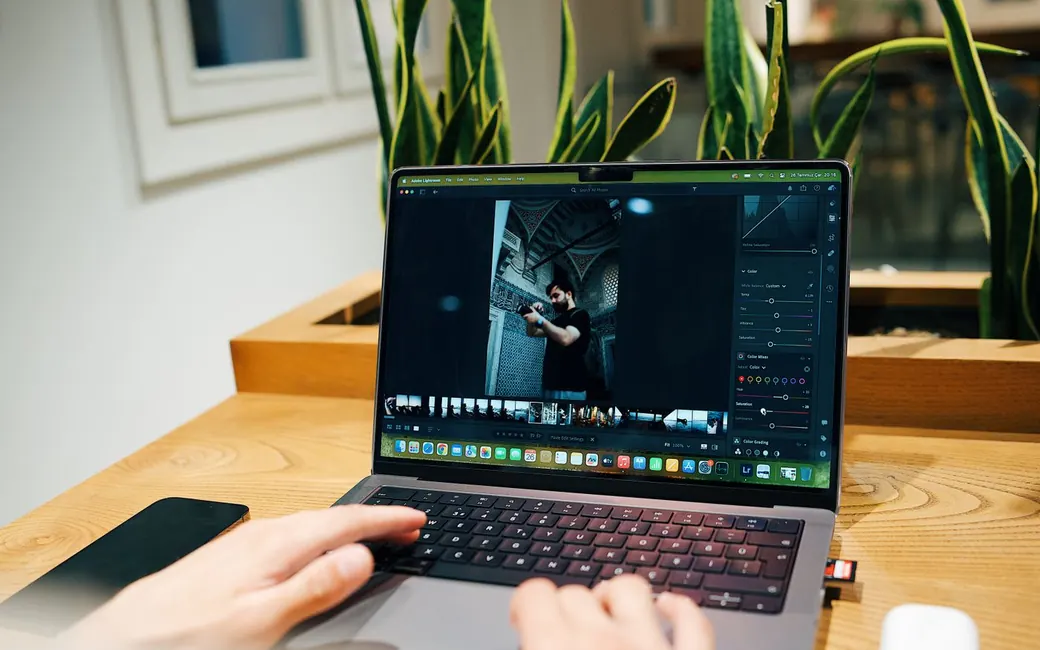 A photographer editing a shoot on a laptop
