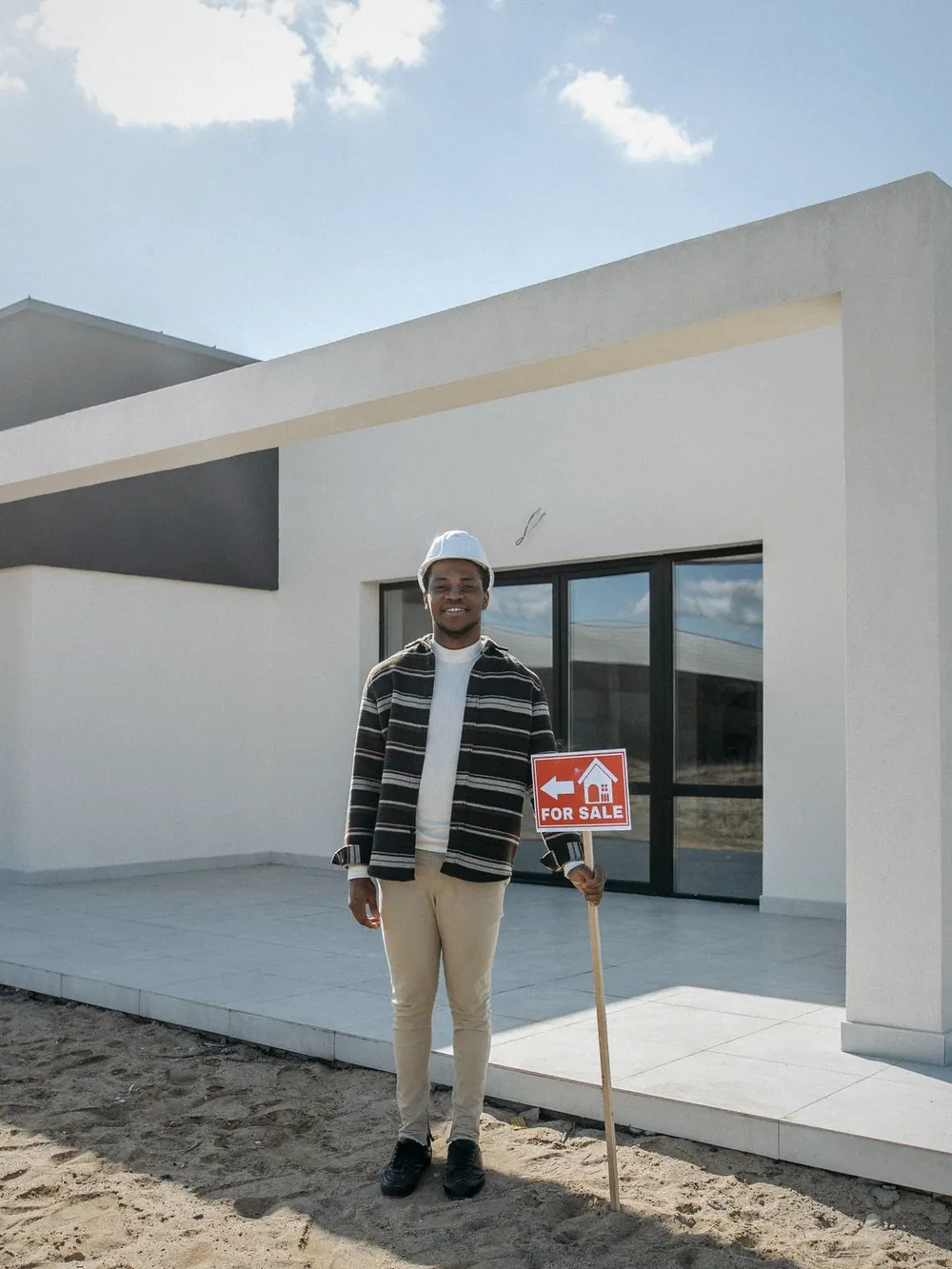 A modern white house with a wide terrace, ready for sale