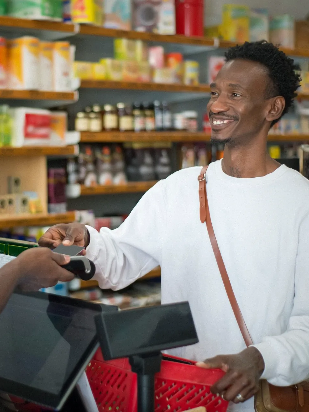 A customer paying at a shop counter